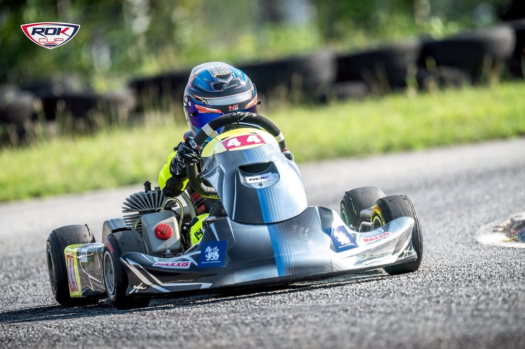 WK kart driver on track at speed